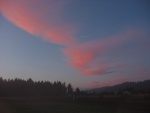 The Brilliant Red Of Sunset Shines Upon These Low Clouds Over My Campground. The Clouds Are Really the Cold Coastal Fog Starting to Come In.  At the end of each day as the colors of sunset starts to color the landscape, I tried to take a good sunset photo that also shows the local area. Sometime the choices of scenery, are somewhat limited as is the case here. As soon as possible, I will make a special album of these "end of day" photos.  Redwood Harbor Guest Ranch, Not far from the coast and several miles South of Crescent City.   (Photo = 115-1576_IMG.JPG)