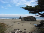 Our Highway Comes Down Off the High Cliffs, Goes Through a Tunnel of Shore Trees, and Emerges at Wide and Sandy Beach Complete With Huge Rocks For the Kids To Climb On.    Beach access, 5 mi South of Westport, CA.  (Photo = 116-1699.JPG )