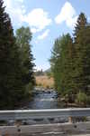 Dry Grass and Low Mountains at Rock Greek Crossing and a Shaded Cool Resting Place Away From the Busy Beartooth Highway Provided a great Spot To Make Back-Up Copies of Our Digital Camera's Full Memory Chip.   On my second trip, we stopped in a shady spot here just beyond this bridge. Here, on a little-used side road was hard-to-find-relief from the hot sun, so our time here was welcomed. We spent some 40 minutes here, because our Nikon D50 camera had filled it's SD memory chip. While my son David, down loaded the 500MB memory chip of photos into his laptop computer and made archival CD copies, I photographed the surroundings onto our second memory chip.  About 15 miles after Red Lodge, MT.  ************************************  (Photo = Summer 2006 0496 ...... ZMM Page 109 ...... WayPt = 126n 5553ft)