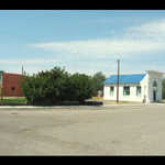 Panorama of a Main Street Whistle Stop in a Nevada Once-Upon-A-Time California Trail Town.    View opens looking northeast toward the desert where the ox drawn covered wagons came into this area. Later the town turned into a Trans-Continental Railroad town. As you scroll around, the first street points east toward Salt Lake City. The buildings you see did business (food, accommodation, and cargo) with the people on the train when it stopped here. Wells, NV.  ************************************ 
(Photo = 123-2357+7 ...... ZMM Page = NA ...... WayPt = 083 5653ft)

