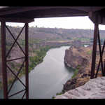 The Snake River Canyon. Twin Falls, ID. 
As this panorama opens you are looking up river. This is the direction of rapids and the Twin Falls. The series of photos for this panorama, were taken from an observation area just east of the huge bridge that connects the north and south parts of the town of Twin Falls. As you scroll half way, you see the bridge, then the second half of this panorama starts anew from the observation area just west of the bridge and shows the down river view.  ************************************  (Photo = 124-2405+7 ...... ZMM Page = None ...... WayPt = 091i ~3600ft)