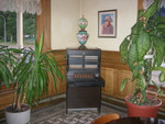  Olive Hotel Lobby, Antique Lamp & Antique Phone Switchboard, Miles City, MT. 
I believe this lamp and switch board were placed here by the imaginative efforts of Hank and Lois Buelow, the previous owners who were, quite evidently, very interested in antiques! ZMM enthusiasts world wide thank the Buelows for their wonderful preservation of "times past" seen here and many, many other places throughout the Olive! 
....The view through the window shows a City Park. This was probably the city park Pirsig slept in, upon his many trips through Miles City when he commuted this way from his hometown, Minneapolis, to Bozeman. 
....This huge City Park was once the NE portion of the old (military) Fort Miles. This fort in the old west was established first, and Miles City "grew up" as a string of frontier businesses plus homes at its perimeter fence and old entrance. So ...... good things can come from "Camp Followers"!  ************************* 
(Photo = 104-0497 ...... ZMM Page = NA ...... WayPt = 097`|h|' 2358ft)