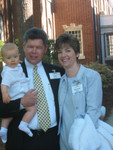 My Daughter Elisabeth With Her Husband Stanley Price Holding Son Mathew. This photo and next three photos, were taken at the occasion of Matthew's baptism at St. Paul's Episcopal Church, Augusta Georgia. In the background if these photos, is the church yard and part of the church. Photo = 4784. 
