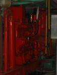 View of the Diesel Engine Co-Generator As Seen From the Engine's Front Right Corner.  I believe the rectangular box seen at top of the engine holds a reserve supply of engine oil. The long vertical cylinder at left is probably for cooling the engine oil.  HVAC Equipment Room, Basement of Science Building, USCA Campus, Aiken, SC.  ************************************  (Photo = 5135 ...... WayPt = `000 |w|' 420 ft)