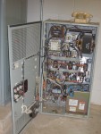This Old Control Box Became Obsolete and Was Taken Out of Service.  Click on photo to get the largest view to read numbers. TR13395, at upper left, Has large three wires which enter and then exit. I believe this is an "electrical current transformer", which has an output proportional to the amount of 3-electrical current passing through it. TR14016, at upper right, looks like a single phase step down transformer, but I am less sure of it's function. At lower left corner are three fuses to block excessive three phase current.   HVAC Equipment Room, Basement of Science Building, USCA Campus, Aiken, SC.  ************************************  (Photo = 5156 ...... WayPt = `000 |w|' 420 ft)
