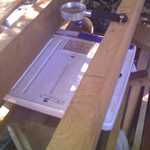 Designing (& Testing) A Solar Regenerated Desiccant Air Conditioner for our Passively Heated Solar Home, by Henry Gurr. This is the fourth of a series of nine photos. Please see the first in this series (pix 16/76) for full explanation. 

Shown here is a close up view of the bottom support of the inclined collector, showing how the bathroom scales is placed, to receive the weight of the whole collector system. This is how I determined how much weight of water the wood shavings would gain, or lose, weight of humidity (water).

Please note magnifying glass in top center of photo. 


Photo_080811_004.jpg