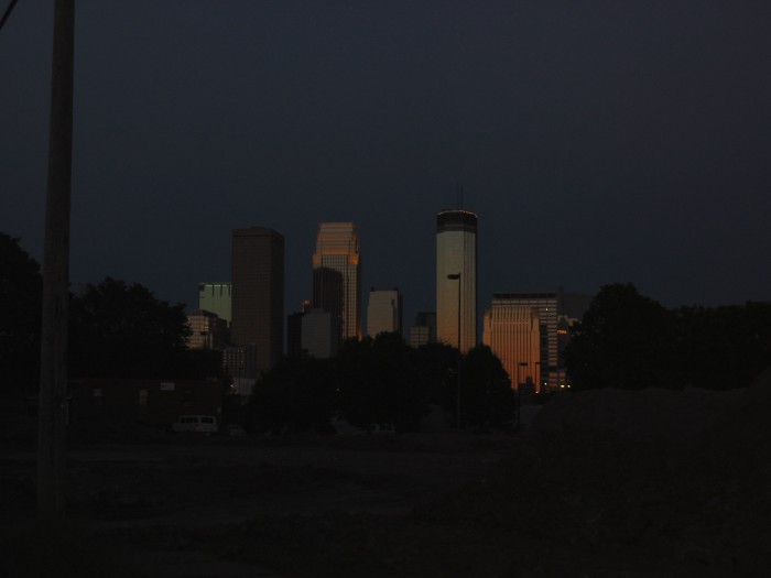 Speculation of Narrator's Route Out of Minneapoli That Early Monday, July 1968?  [Letter from Robert Pirsig 30 Sept 2005 states:] "When John and Sylvia and Chris and I set out that morning we could not have dreamed that 37 years later we would get questions from around the world about which route we were going to take, yet here they are. I wonder what the questions will be like 37 years from now.  "I've marked up the map you sent me with my best guess, but it could be wrong. The exact route out of Minneapolis is very vague in memory but I seem to recall that we went north to the US 10 highway that still follows the old Northern Pacific railroad (now Burlington Northern) through Anoka, St, Cloud, and Fargo to the West Coast. The freeway that replaced it was I-94. US 10 goes more north than we wanted to go, so after a while we worked our way west and north along a number of roads to highway 210 and followed it to Oakes, North Dakota.  "The references to Excelsior and Savage [In Lila] were for other [shorter] trips that John and I took. Only the first chapter touched down there, not the trip itself. I threw in those names because they seemed to have a mild "not-quite-in-this-world" connotation that might help foreshadow things later on in the book. The name, "Phaedrus," was used for the same purpose.  "If we had been smarter we probably would have taken Hwy 55 but we didn't really have any route in mind and I don't remember even looking at a map as we left Minneapolis. We just eyeballed it, and went north and west along whatever looked good at the moment. The angle of the sun was our main guide. To really reproduce the feelings of that trip you should just estimate the general direction you want to go and pick a road--any road--and see where it takes you. Road numbers and maps are very static. Not knowing where you're going is more Dynamic and that is how we felt that day." For a WebMap showing (somewhat) of what Pirsig above mentioned, go to my "Home Page", click on "ZMM Links" in menu, and scroll down to Gary Wegner.  Imagine Mid Summer, early AM, just West of down town  Minneapolis, MN. Note: In the Summer of 2002, I was not aware of the route mentioned by Mr. Pirsig above. My best estimate at the time, based on physical clues, was the Rt 55 mentioned by Mr. Pirsig above. As a result, my photos you see in this Album are for Rt 55. In the Summer of 2006 I started in Minneapolis, traveled along Rt 10 then Rt 210, to reach Breckenridge, MN. (These are the routes mentioned by Mr. Pirsig above.) Since I have also traveled Rt 55, I can say most definitely that Rt 55 is a much better fit to the physical route clues and scenery descriptions given in ZMM. For example Rt 55 has many more lakes, duck sloughs, and is a narrow two lane road that is much less commercialized and thus less traveled highway. Also Rt 55 vastly better fits the ZMM clues about the missed turn just prior to a freeway. For these reasons, Rt 55 would be quieter, safer, and a  more satisfactory Pirsig pilgrim experience! The 3rd photo next provides some suggestions how to leave Minneapolis. However, pilgrims should heed Mr. Pirsig's above advice. They might well improvise their own back country roads.  ************************************  (Photo = 102-0254 ...... ZMM Page = 003 ...... WayPt = -011w)