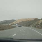 As We Drive Below The Sun Less Gloom Of A Uniform Overcast Of Coastal Fog, Huge Coastal Sand Dunes Are Seen 5 Minutes After The Previous Photo, As David Matos & Henry Gurr Drive, SouthSouthEast Along Rt-9 Towards Santa Cruse, C A. 

File = DSC 0317 Resize602x400